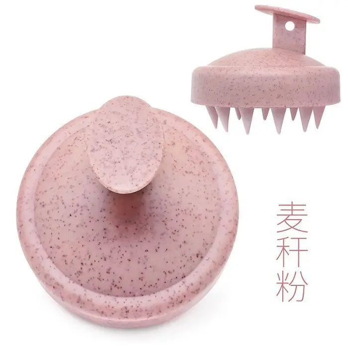 Silicone scalp massage brush comb in a pink color, designed for head massages and hair care.