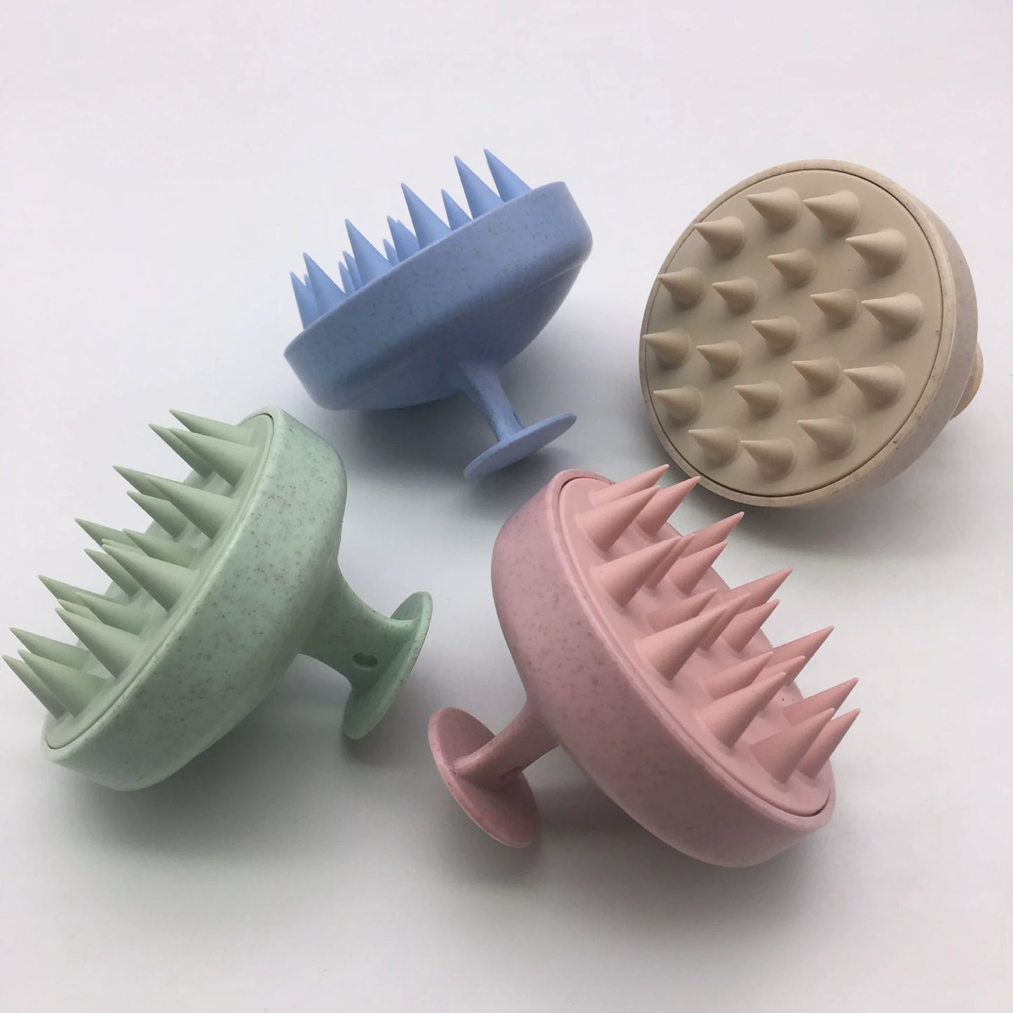 Silicone scalp massage brush in various colors, designed for scalp care and massage.